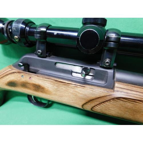 USED THOMPSON CENTER R-55 CLASSIC BENCHMARK 22LR 18" SEMI AUTO RIFLE. 1-10RD MAG & JAPANESE TASCO 3-9X40 SCOPE LAMINATE STOCK. HEAVY BBL. 98% (Consignment)