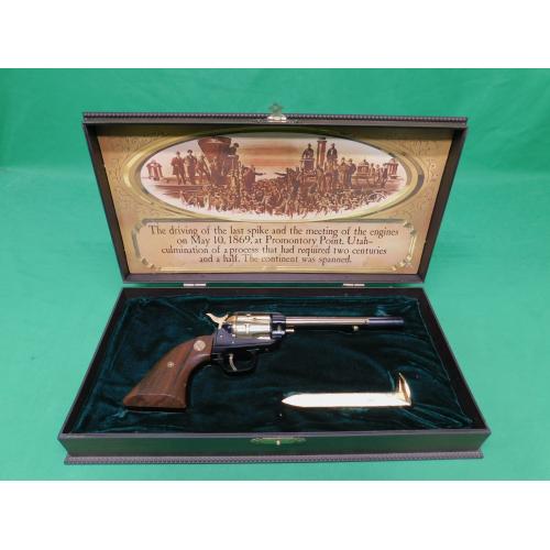 USED 1969 COLT FRONTIER SCOUT GOLDEN SPIKE .22LR 6" REVOLVER. BLACK AND GOLD AS ISSUED IN DISPLAY CASE W/SPIKE PAPERWORK. 98% ESTATE COLLECTION (Consignment)