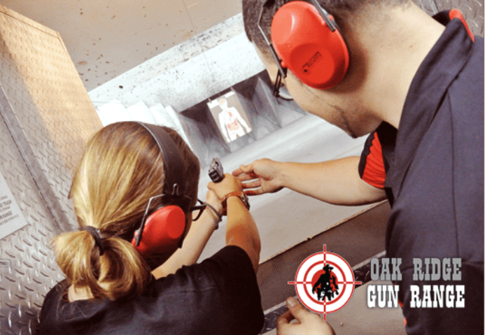 a trainer training a trainee to shoot