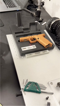 Compliance laser engraving on firearm receiver at City Armory