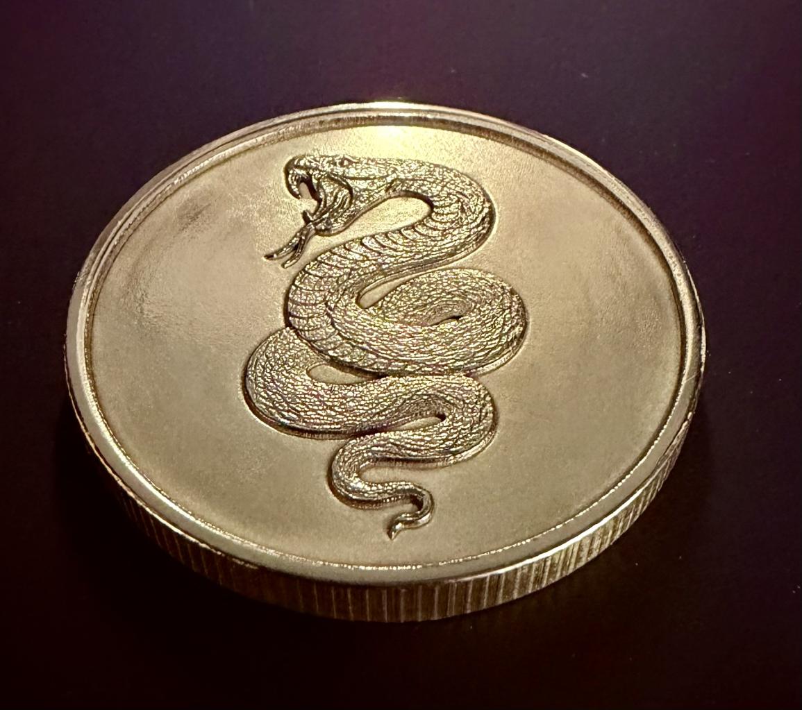Snake detail on back of Lawson and Cooper Arms challenge coin